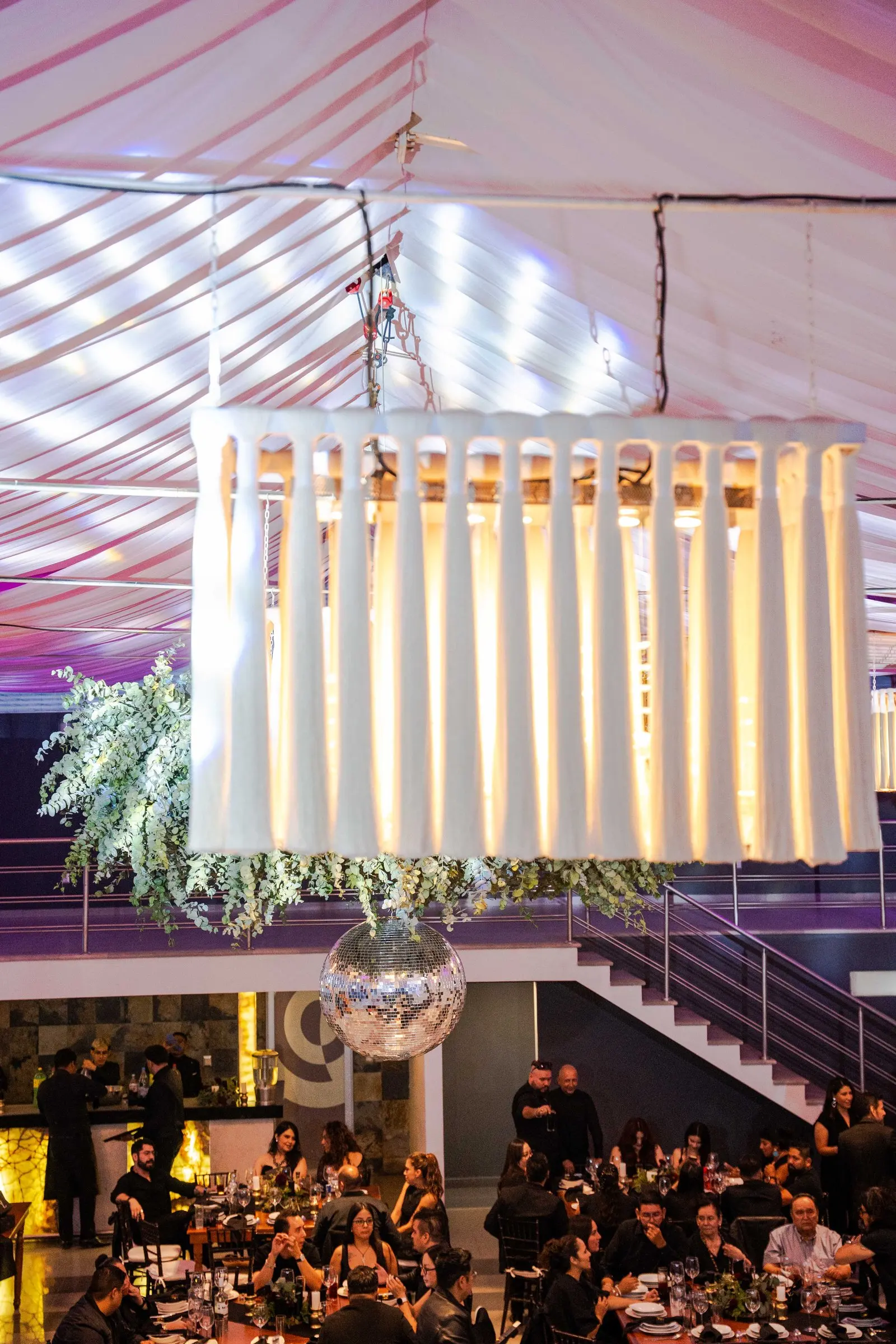 Una lámpara de listones sobre el salón lleno